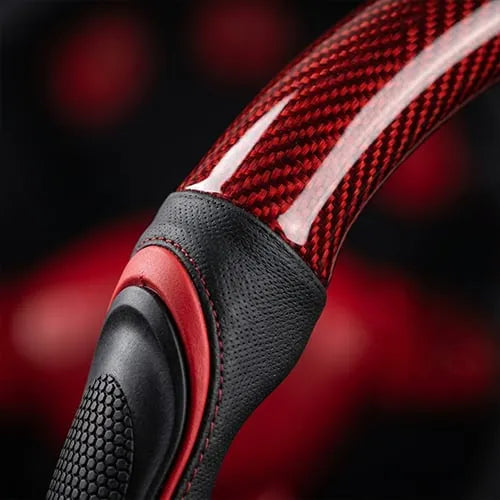 Close-up of textured side grip and red patterned steering wheel cover