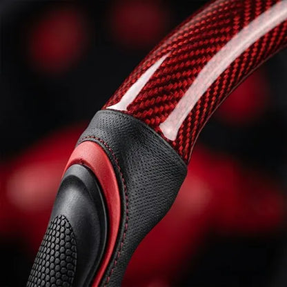 Close-up of textured side grip and red patterned steering wheel cover