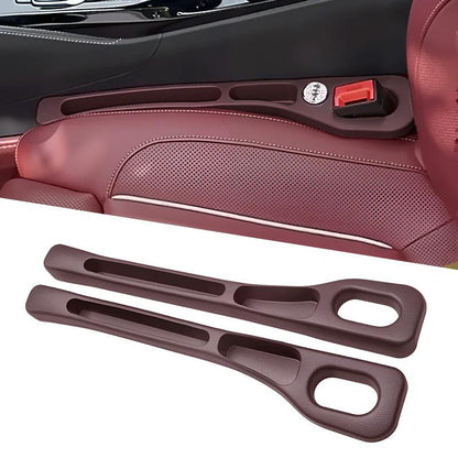 Brown seat gap organizer installed beside a seat with a matching pair shown below