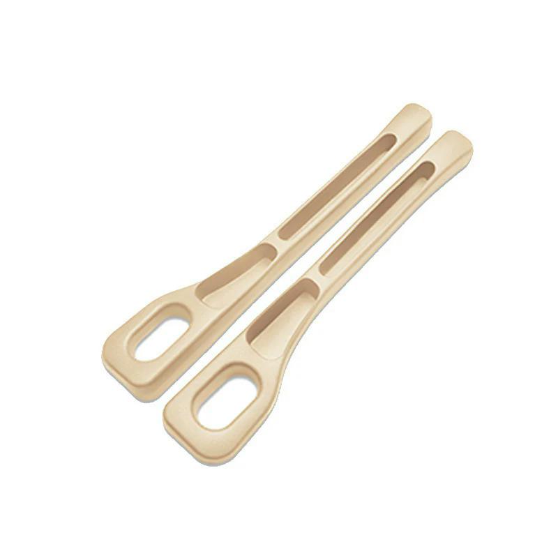 Beige pair of dual-slot car seat gap organizers on a white background